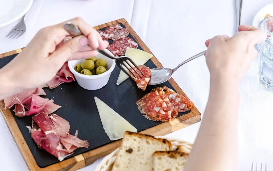 Pan, aceitunas y embutidos en una mesa de degustación
