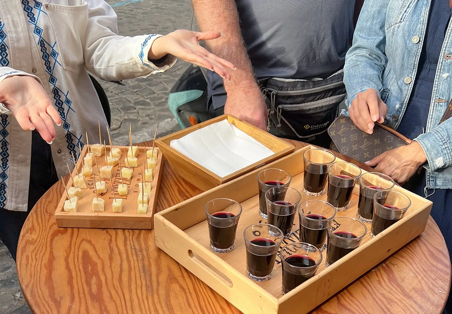 Wine being poured into tasting glasses on a Trastevere food tour